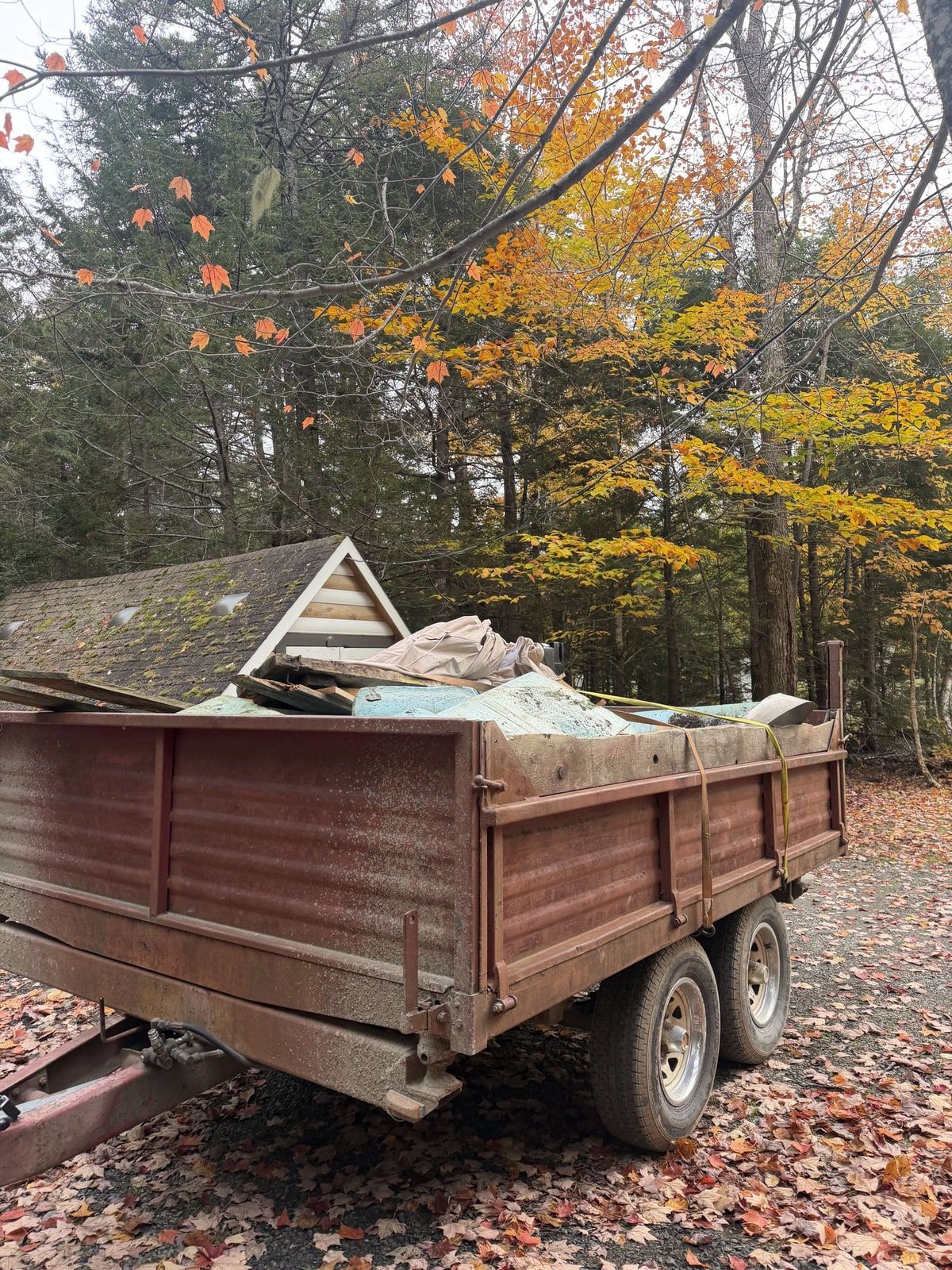 Cushions, timber and other bulky items loaded into a trailer.